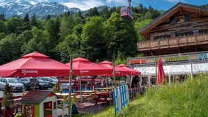 A mountain resort with a cable car, outdoor seating, and a restaurant. - Balcony overlooking the Mont-Blanc chain☀️parking (Les Houches)
