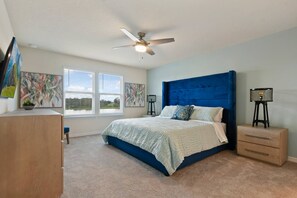 A bedroom with a bed, a ceiling fan, a window with blinds, and artwork on the walls. - 5-bedroom townhome with a screened plunge pool at Solterra Resort, near Disney (Davenport)