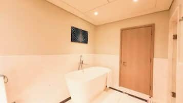 Bathroom features a bathtub and towel rack.