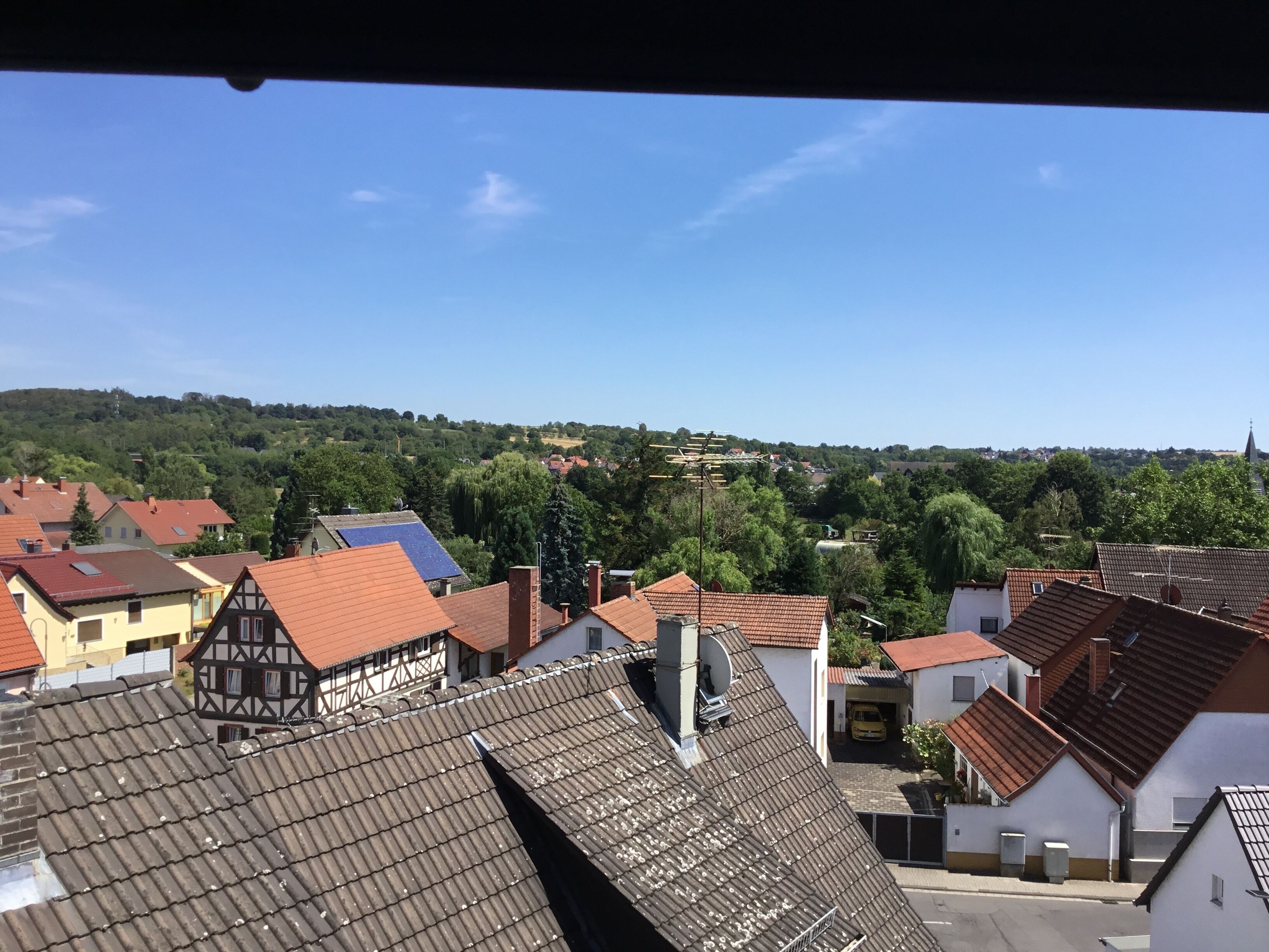 A residential area with traditional European architecture, including half-timbered houses and red-tiled roofs.
