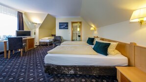 A hotel room with two beds, a desk, a chair, and a television. - Hotel Zum Adler (Nidderau)