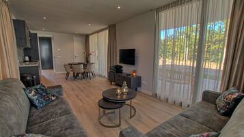 Luxury Room | Living area | 55-inch Smart TV with digital channels, TV, Netflix