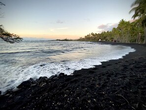 A beach with black sand, waves, and palm trees. - #70 Pog`s Place Pahala at Black Sand Beach, Punalu (Pahala)