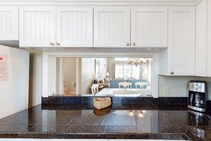 Enjoy cooking in this well-equipped kitchen with a convenient coffee maker and ample counter space.