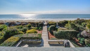 A pathway leading to a beach with a clear view of the ocean.
