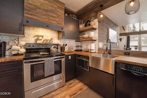 Enjoy cooking in this kitchen with an oven, dishwasher, and stainless steel range hood.