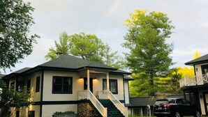 A two-story house with a porch and a staircase leading to the second floor. - Ever After <br>Lakefront Splendor (Florence)
