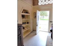 Enter a serene space with a beautifully maintained lawn and a picturesque view.