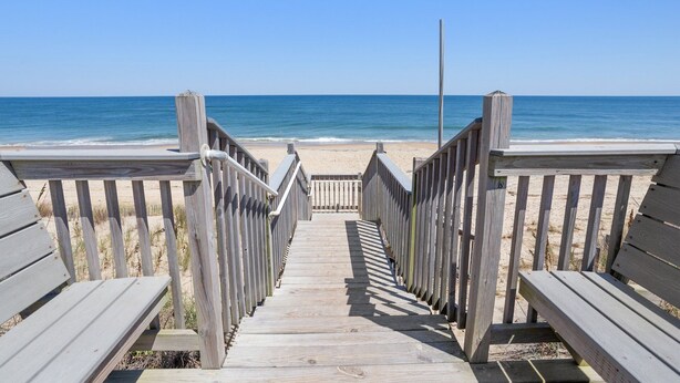 A wooden boardwalk leading to a beach with a clear view of the ocean. - Happy Days: 2-Min Walk Beach, Pool, Hot Tub, 7BR (Southern Shores)