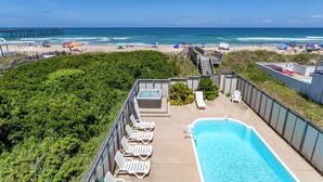 A rooftop pool with lounge chairs, a hot tub, and a view of the beach and ocean. - 6067 The Sand Pebble *Pool *Game Rm *Dog Friendly (Nags Head)