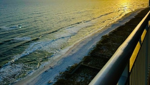 A sunset over a beach with a railing and a clear sky. - Neaux Worries: Newly remodeled Ocean Front 16th Floor Pearl Condo! (Navarre Beach)