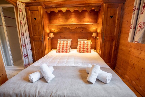 Relax in a warm, inviting space with a plush bed and comfortable amenities.