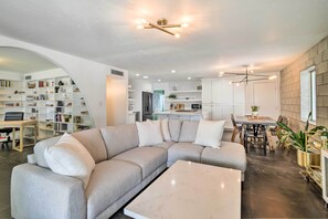 Relax in this stylish living space with a large L-shaped sofa and matching ottoman, paired with a sleek coffee table.