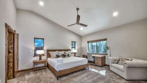 A bedroom with a bed, a desk, a chair, and a sofa. - New Tahoe Cabin with Hot Tub Games and EV Charger (South Lake Tahoe)