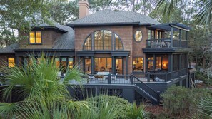 A large, multi-story house with a balcony and a staircase leading to the upper floor. - KIAWAH, 4BR Luxury Home, Saltwater POOL & Incredible PORCHES! Golf VIEWS! Short Stays! (Seabrook Island)