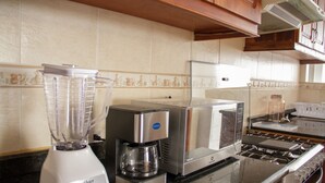 A kitchen with a blender, toaster, and stove. - NICE APARTMENT, CLOSE TO EVERYTHING. (Quito)