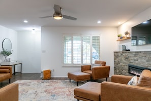 Relax in this inviting living room with a fireplace, flat-screen TV, and comfortable seating area.