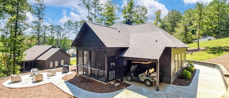 A modern house with a garage, a covered patio, and a driveway.