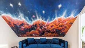 A room with a blue sofa, a galaxy-themed ceiling mural, and a small round table. - Charming & Comfy Gem ~ 10 Mins to Downtown ~Patio! (Chicago)