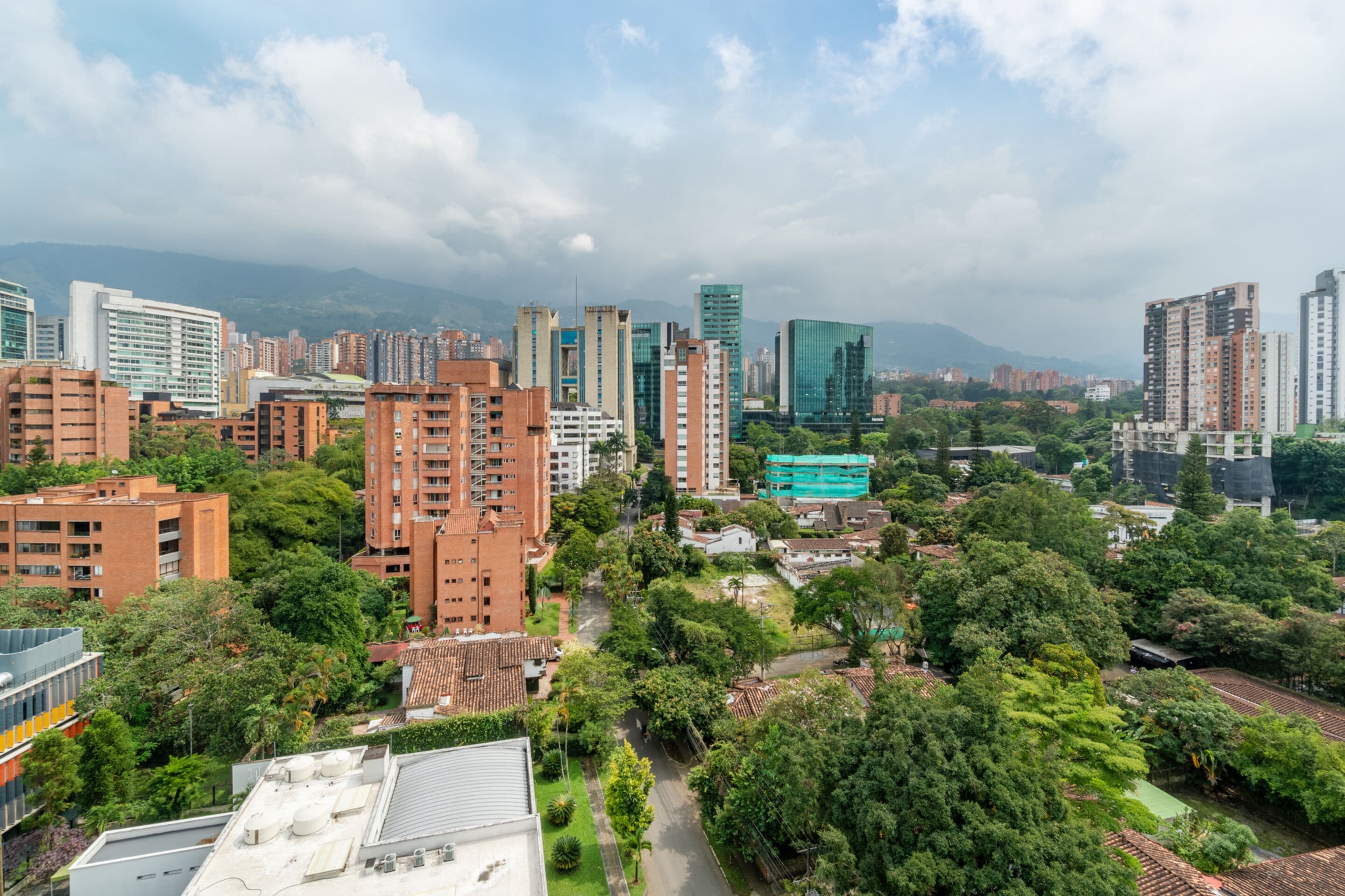 A high-rise urban area with dense residential buildings, green spaces, and a mix of modern and traditional architecture.