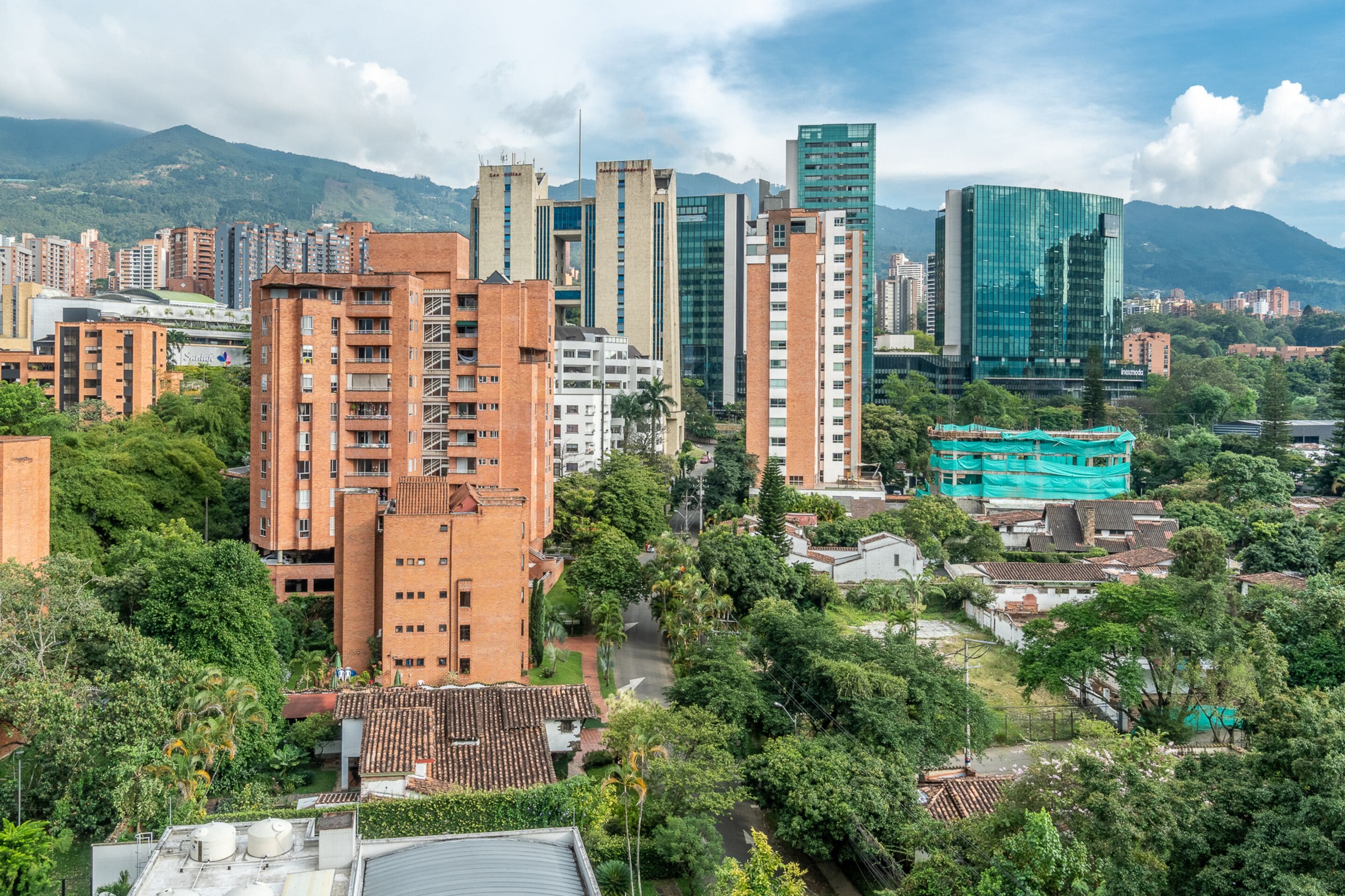 A cityscape with a mix of modern and traditional buildings, including high-rise apartments and a construction site.