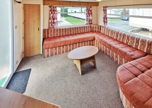 Living area - Comfortable caravan with one double and two twin. (Cross Inn, Nr New Quay)