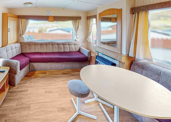 Living area - Comfortable caravan with one double and two twin. (Cross Inn, Nr New Quay)