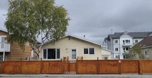 A row of single-story houses with a wooden fence in the foreground. -  YK Aurora B&B  (Yellowknife)