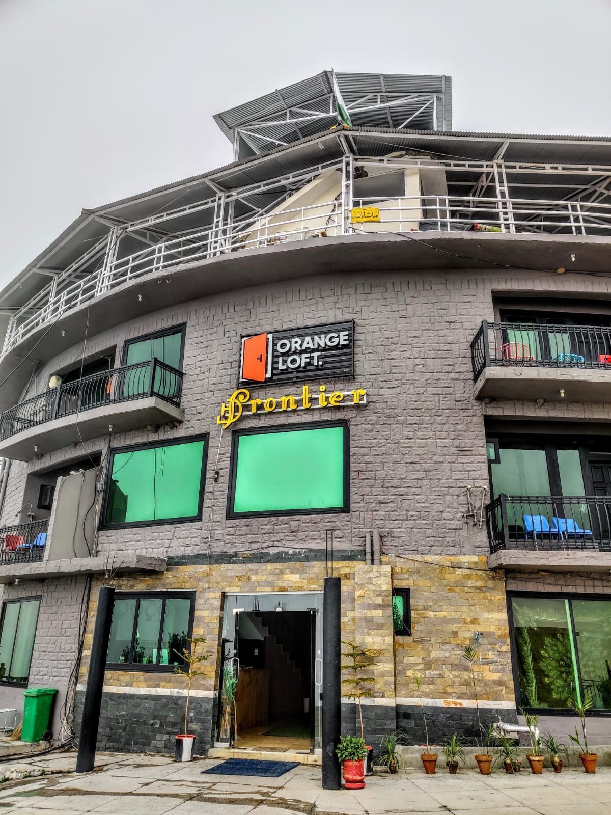 A building with a sign for Orange Loft and a sign for Frontier.