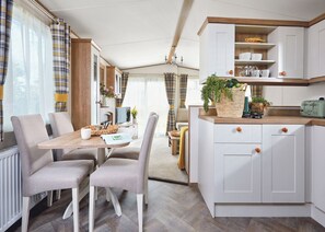 Dining - Spacious and luxurious 12-foot-wide caravan with one double and one twin. (Axminster)