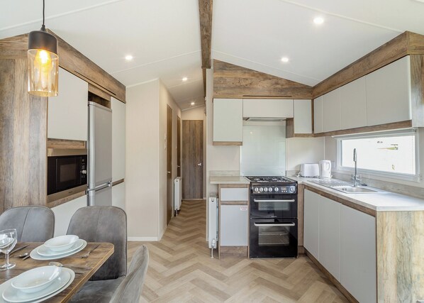 Fridge, oven, stovetop, toaster - 12ft-wide luxury caravan with one double and two twin. (Charmouth)