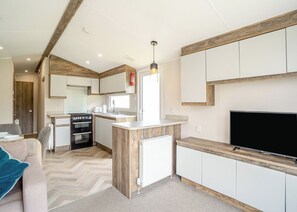 Living area - 12ft-wide luxury caravan with one double and two twin. (Charmouth)