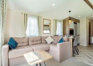 Living area - 12ft-wide luxury caravan with one double and two twin. (Charmouth)