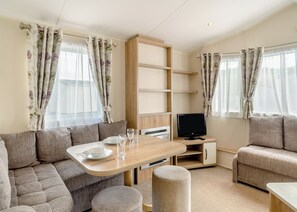 Living area - 12ft-wide luxury caravan with one double and one twin. (Charmouth)