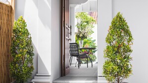 A staircase leading to a dining area with potted plants on either side. - Villa Anahera (Seminyak)
