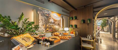 A breakfast buffet with various food items and a coffee station.