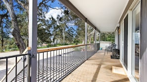 Enjoy al fresco dining and take in the views of the surrounding trees from this balcony.