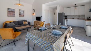 A modern apartment with a dining area, kitchen, and living room. - Le Clos Moguer by Interhome (Quiberon)