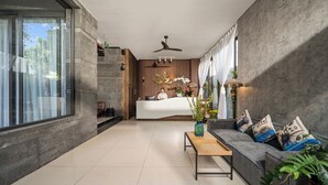 A modern living room with a sofa, a coffee table, and a large window. - Tashi Oasis Hotel & Apartment (Da Nang)