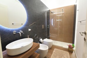 Combinació de dutxa i banyera, assecador de cabells, bidet i tovalloles 