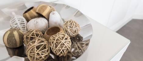 A variety of decorative items on a reflective surface.
