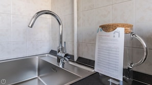 A modern kitchen with a stainless steel sink, a chrome faucet, and a corked bottle on the countertop. - Italianway Comfort - Borsieri 11 B (Milan)
