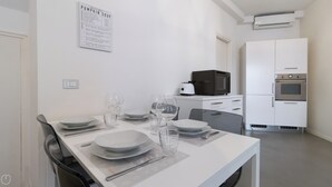 A modern kitchen with white cabinets, a microwave, and an oven. - Italianway Easy - Plinio 64 (Milan)