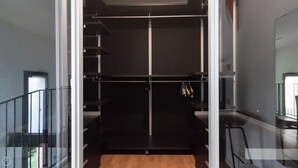 A modern closet with a mirrored door, a wooden floor, and a metal railing. - Italianway - Salomone 51 (Milan)