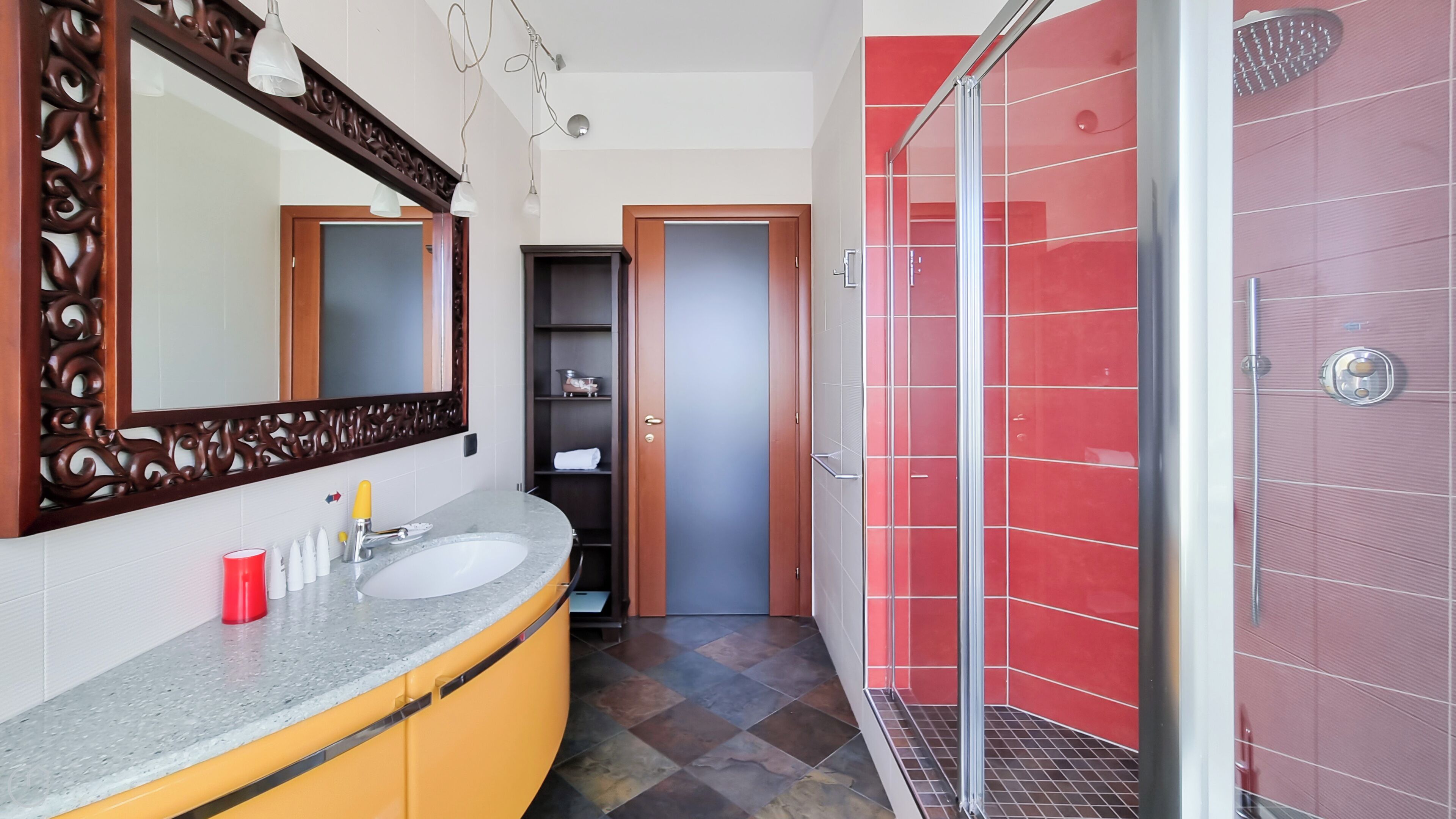 Une salle de bain avec un lavabo, un miroir et une douche.
