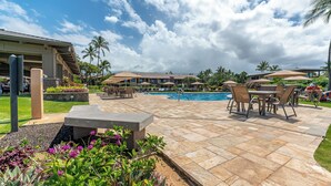 A pool area with lounge chairs and umbrellas, surrounded by palm trees and a clear sky. - Townhouse Retreat with Ocean Views From Upper & Lower Lanai - Wailea Ekahi #30B (Wailea, Maui)