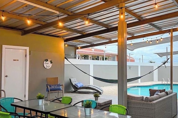 Gazebo with sitting areas and a kitchenette with BarBQ.
