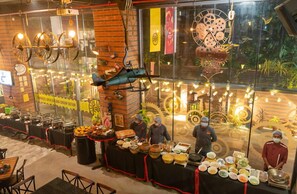 A buffet setup with various food items and staff serving. - Beyzaa Hotel & Suites , Kolkata (Barasat)