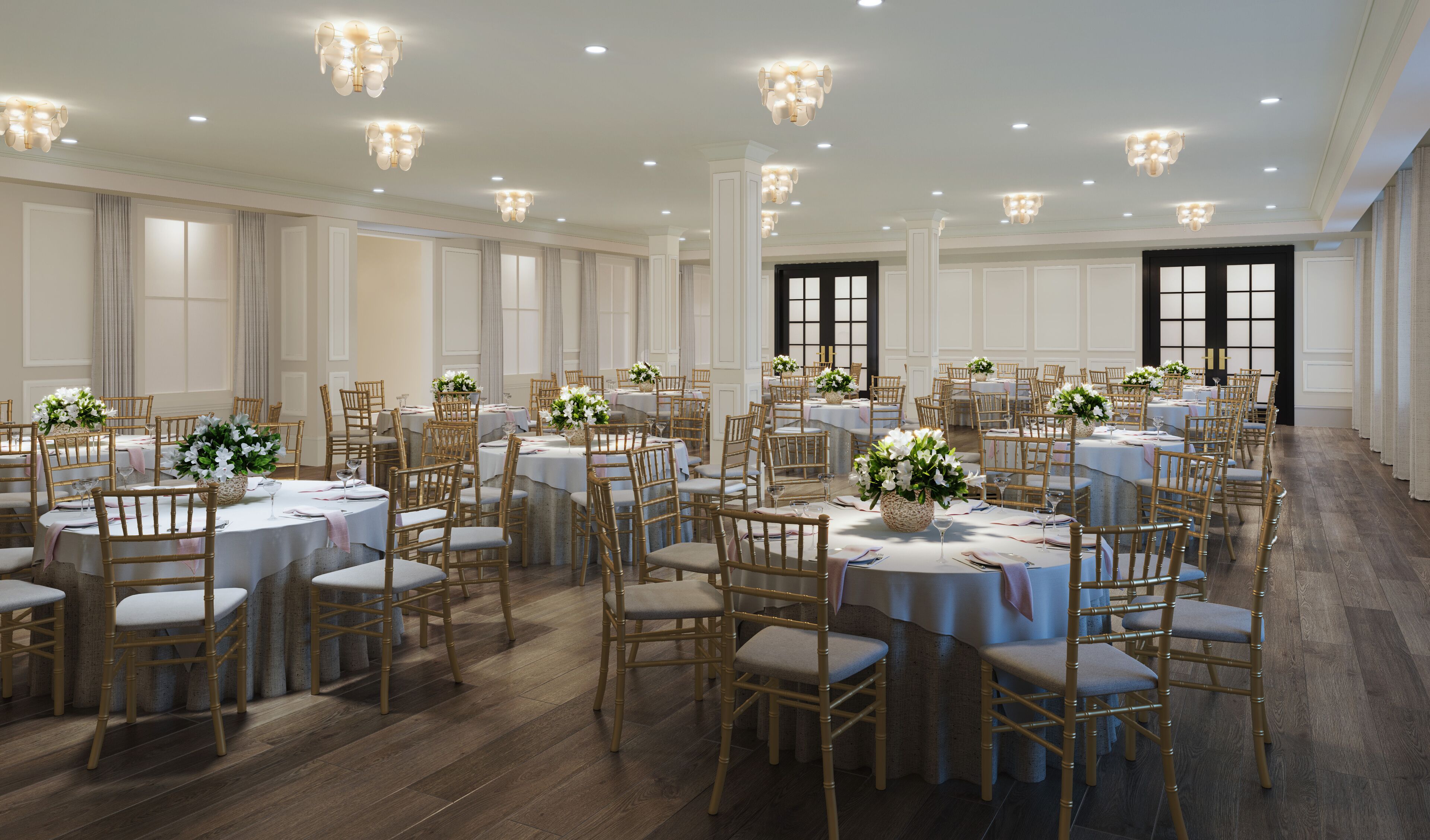 A spacious banquet hall with round tables, wooden chairs, and elegant chandeliers.