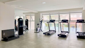 A gym with treadmills, a stationary bike, and weight machines.